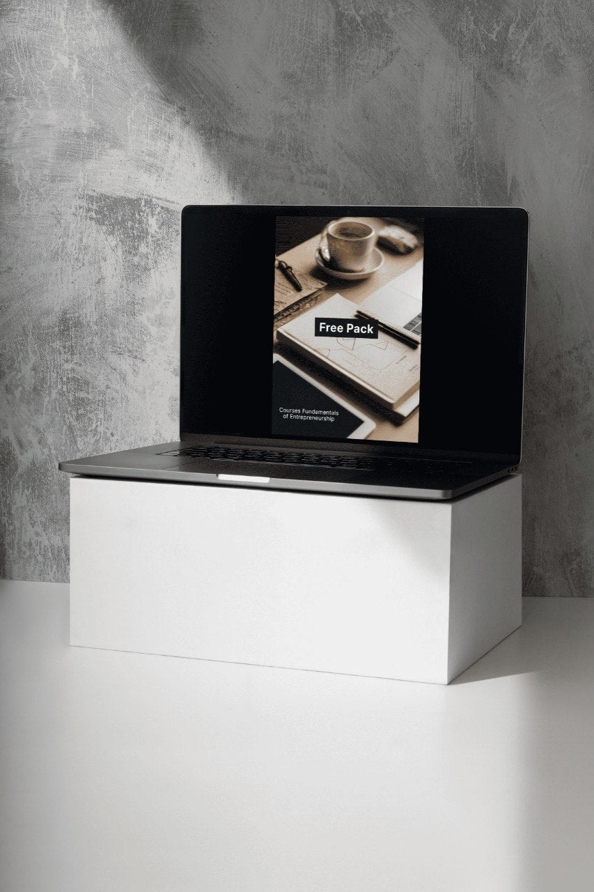 Laptop on a white stand with a gray concrete wall background